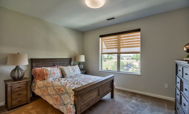 Interior view of a bedroom at Silvercrest at College View senior living community.