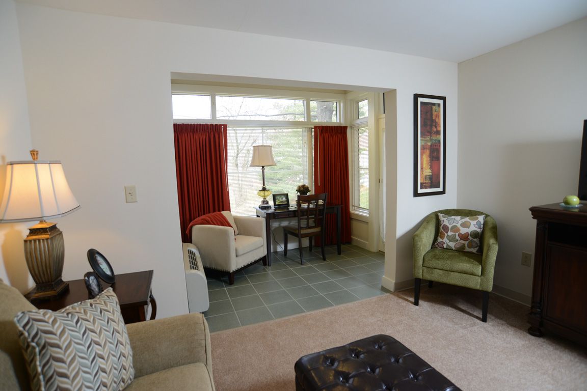 Interior view of Aspenwood Senior Living Community featuring modern furniture, decor, and electronics.