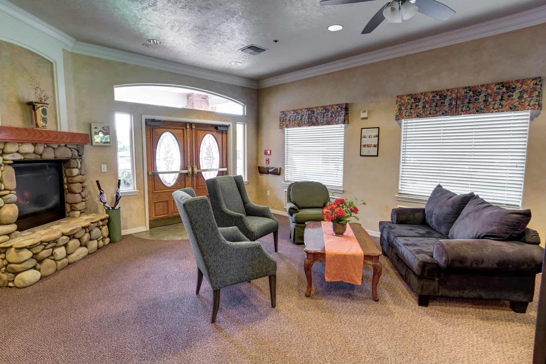 Interior view of Overland Court Senior Living with modern decor, electronics, and cozy living room.
