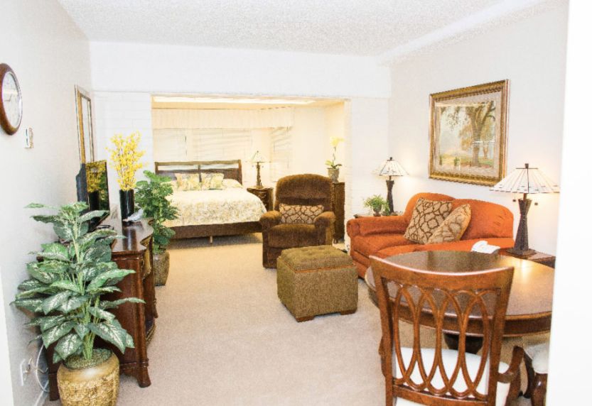 Senior living community Rowntree Gardens featuring furnished living, dining, and bedrooms.