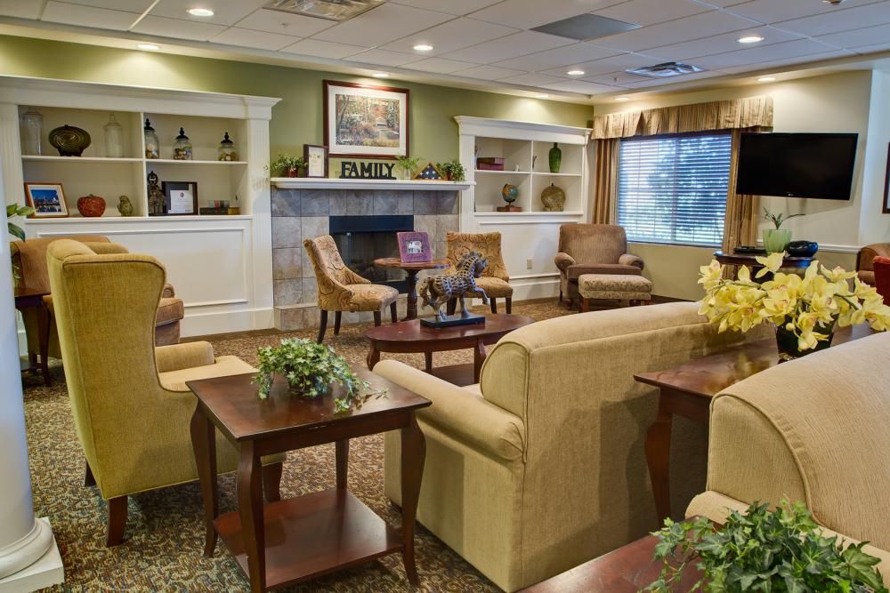 Senior living community room at Long Cove with modern furniture, electronics, and residents.