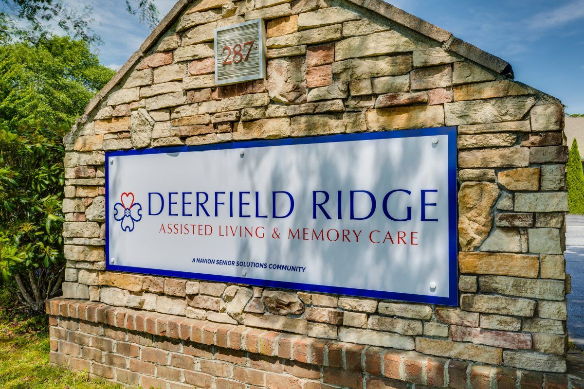 Deerfield Ridge Assisted Living facility exterior, featuring countryside architecture and nature.