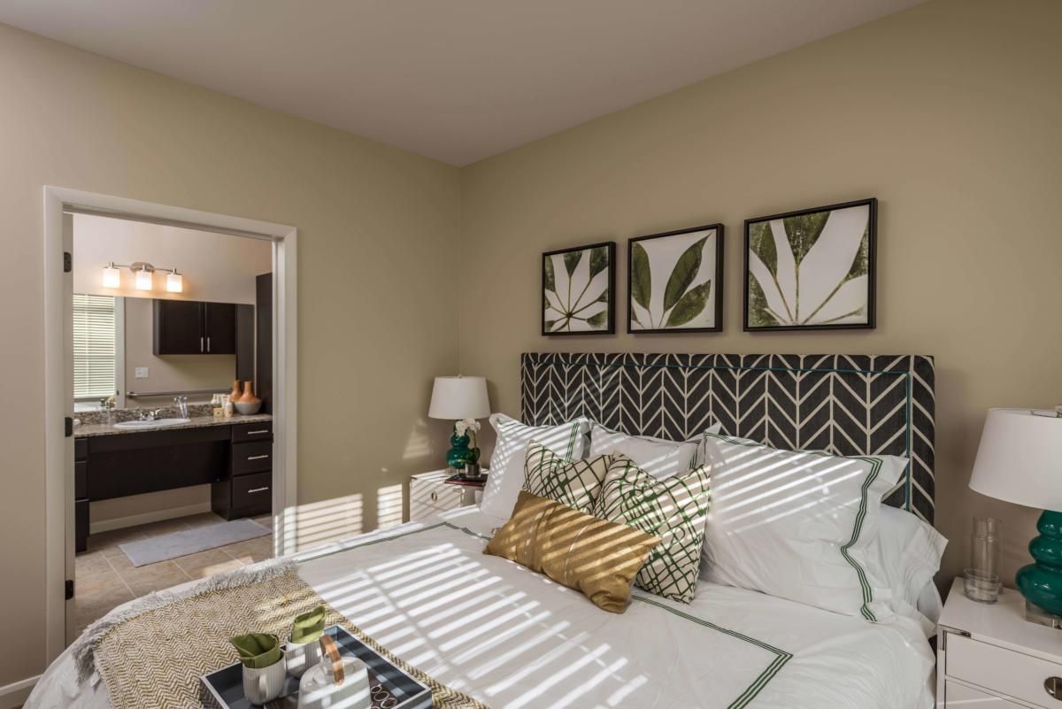 Interior design of a bedroom at Heartis Peoria senior living community featuring art and decor.