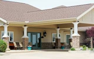 Senior living community Courtyard Estates of Galva, showcasing its architectural building and porch.