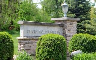 Courtyard Estates Of Galva, a serene senior living community surrounded by lush greenery and trees.