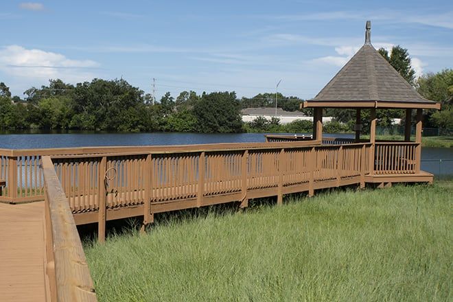 Scenic view of Brookdale Highlands senior living community with waterfront houses, bridge, and gazebo.