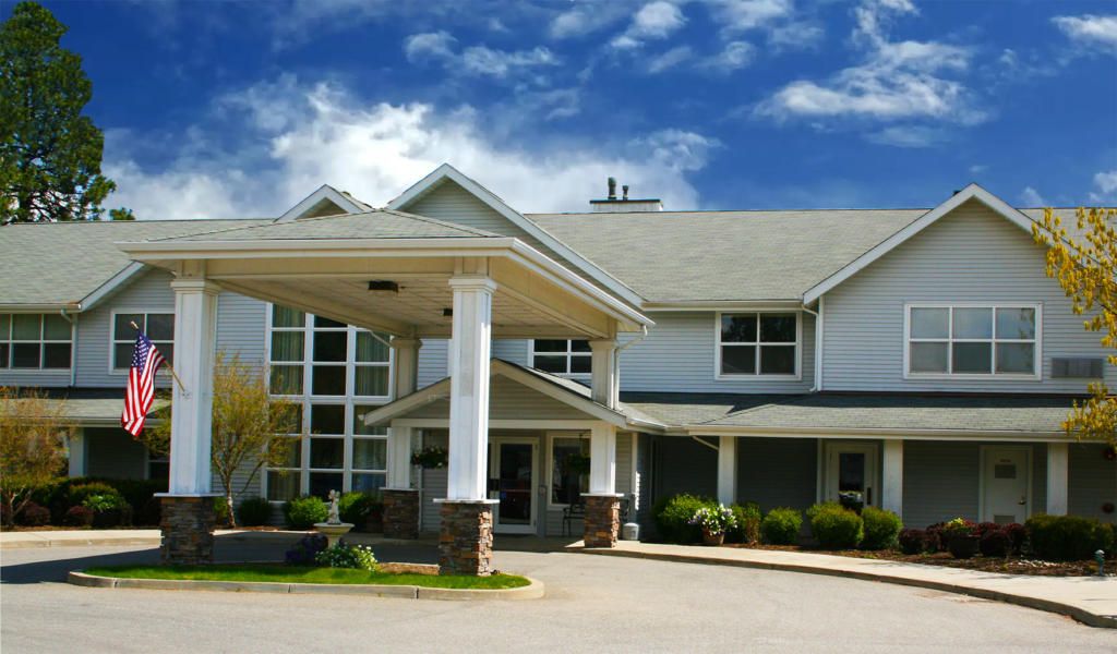 Architecture of Legends Park Assisted Living Community featuring housing buildings and portico.