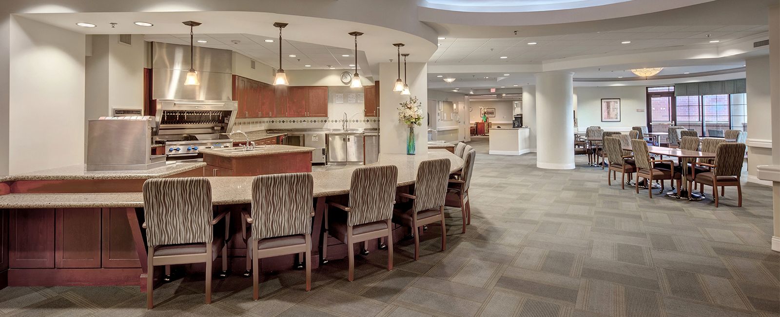 Senior living community at Lakeview Village featuring modern architecture, dining room, kitchen island, and furniture.