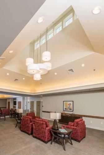 Interior view of Heartis Peoria senior living community featuring a reception room with elegant decor.