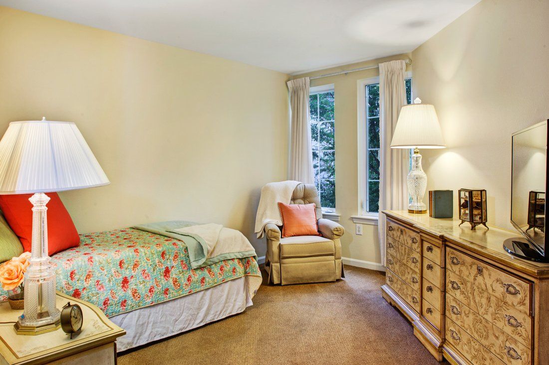 Interior of a bedroom in Sunrise of Mission Viejo senior living community with modern decor.
