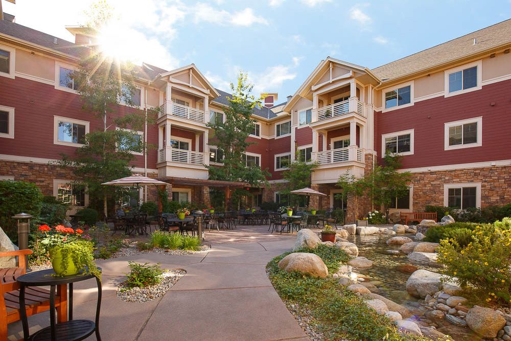 Senior living community at The Bridge At Post Falls featuring urban architecture and greenery.