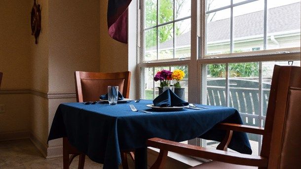 Interior of Arden Courts Of Wayne senior living community with furnished dining room.