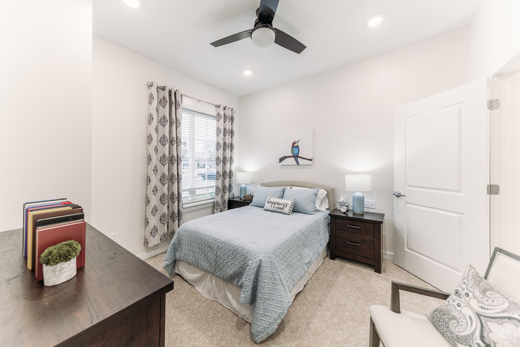 Interior view of a bedroom at The Capstone at Station Camp senior living community.