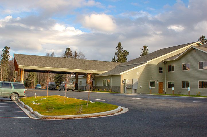 Riverside Assisted Living in Soldotna, featuring urban neighborhood with cars and greenery.