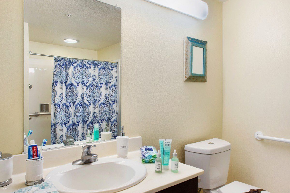 Senior living bathroom in Sunrise of Yorba Linda featuring sink, toothbrush, and other amenities.