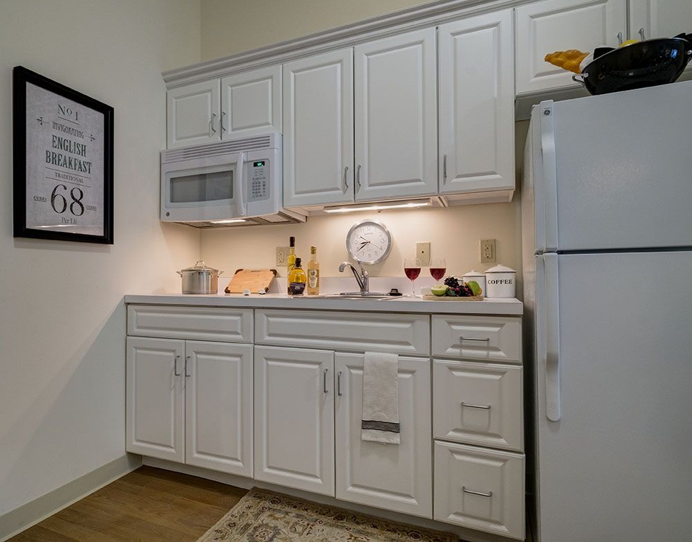 Interior of a kitchen at Arbors at Taunton senior living community, featuring modern appliances.