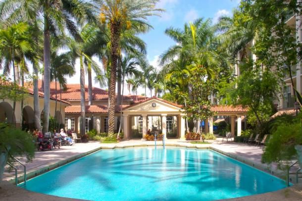 Senior living community, The Carlisle Palm Beach, featuring resort-style villa with pool and hot tub.