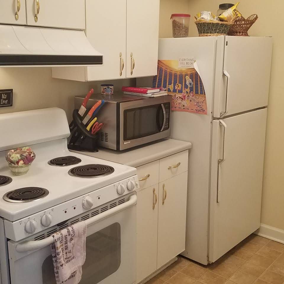 Kitchen appliances including refrigerator, microwave, oven in Gordon Oaks Senior Living Community.