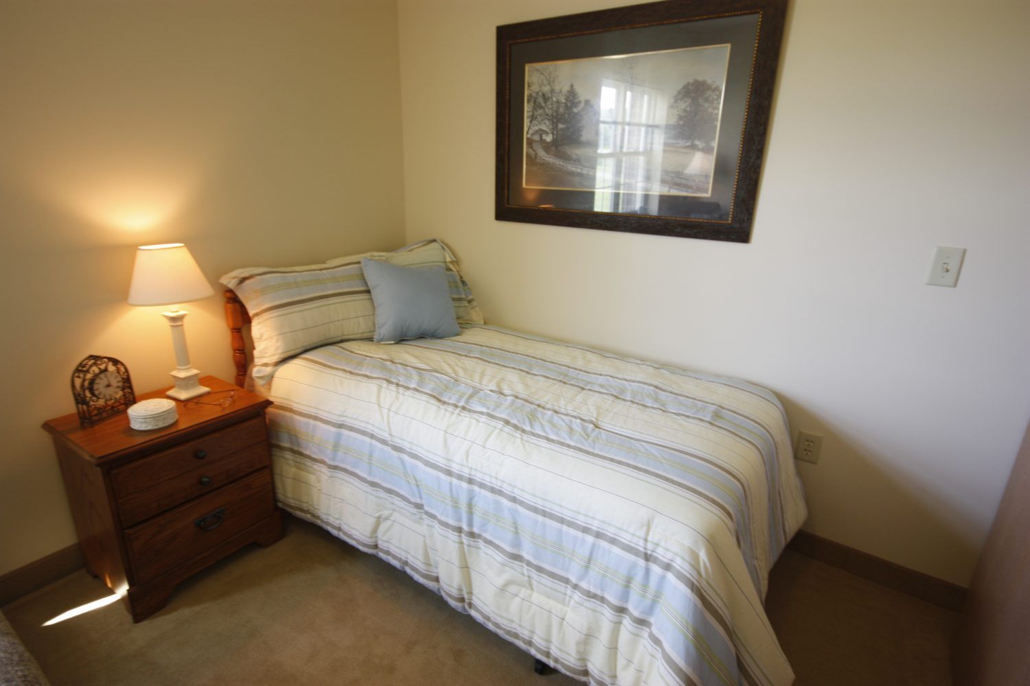 Interior view of a cozy bedroom at Heritage Woods of Freeport senior living community.