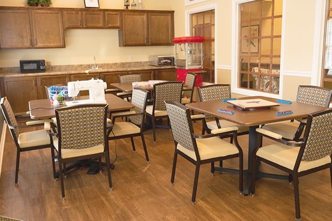 Interior view of Brookdale Gallatin senior living community featuring dining area, kitchen appliances, and decor.