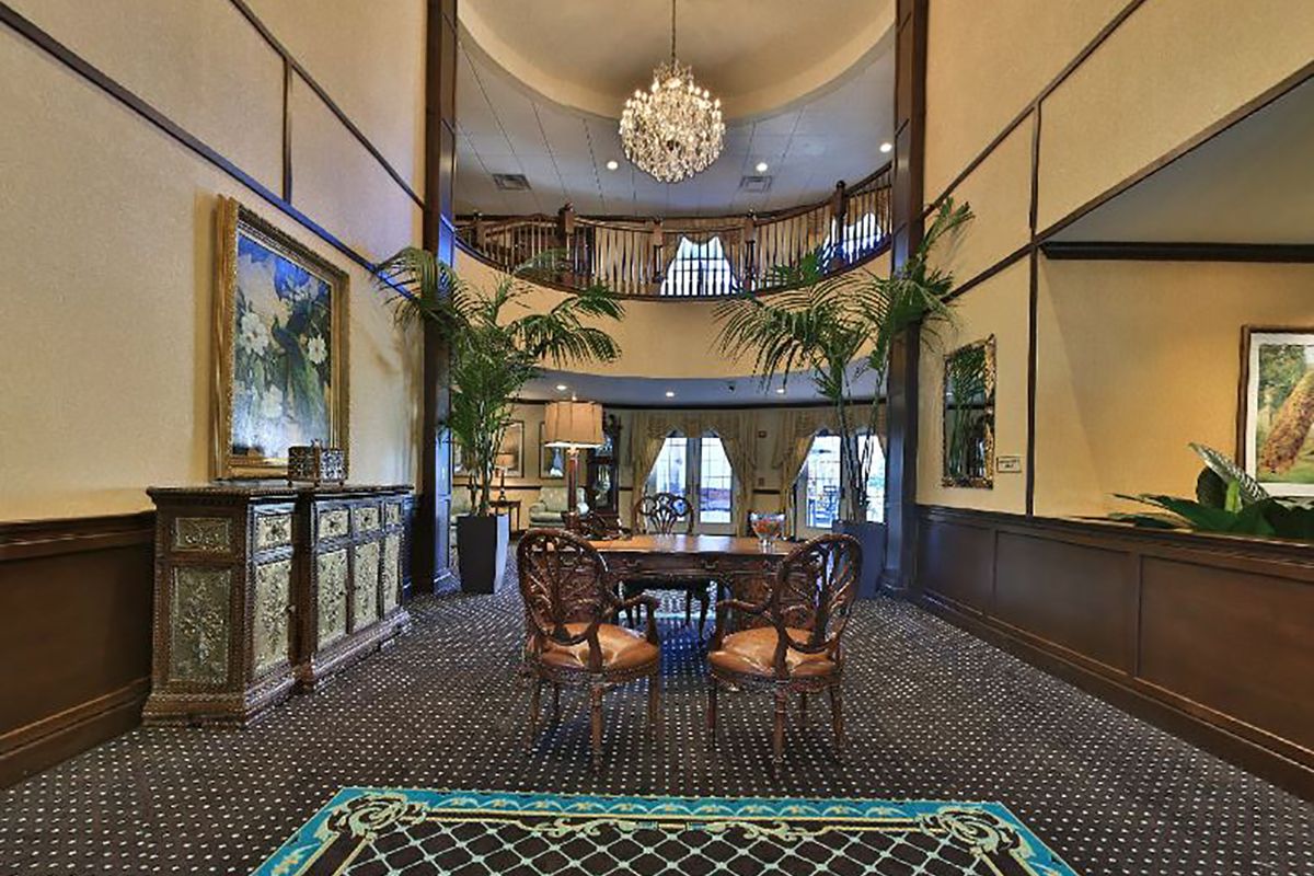 Interior view of Brandywine Living at Voorhees featuring elegant dining room with chandelier and art.