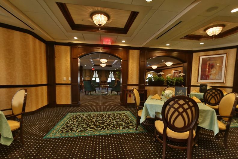 Interior view of Brandywine Living at Voorhees featuring elegant dining room with art and decor.