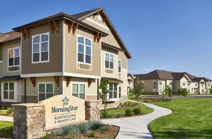 Suburban senior living community, MorningStar of Fort Collins, featuring condos amidst greenery.
