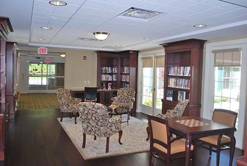 Senior living community library and dining room at Canterbury Village with modern home decor.
