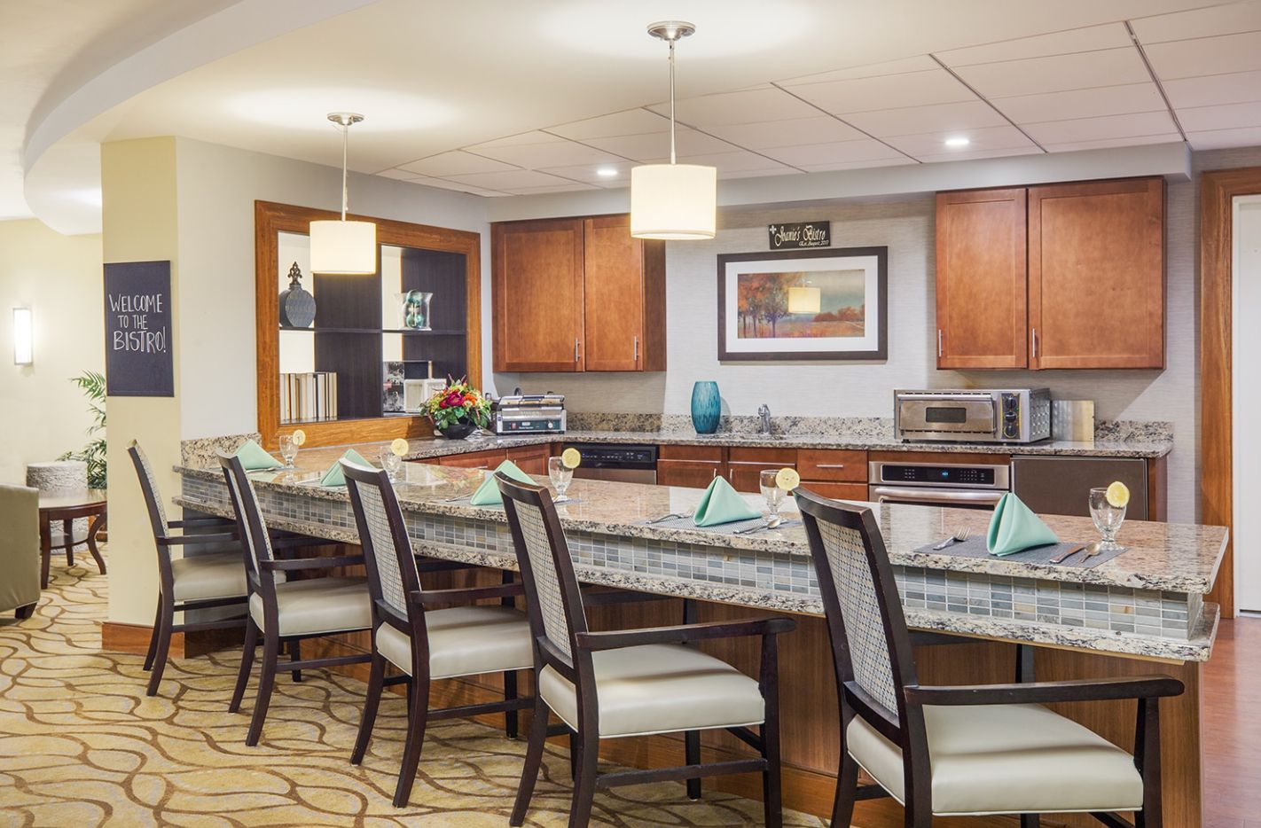 Interior view of The Residence At Watertown Square senior living community featuring dining and kitchen area.