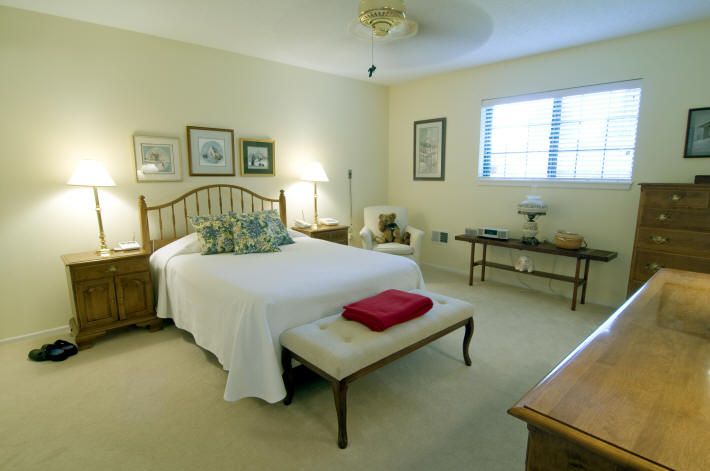 Corner view of a furnished bedroom in Foxwood Springs senior living community.