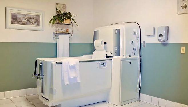 Senior living community at Knolls West Assisted Living with laundry facilities and CT scan device.