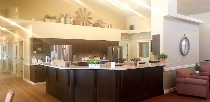 Interior view of a well-furnished kitchen and living room at The Cottages at Lochsa Falls senior living community.