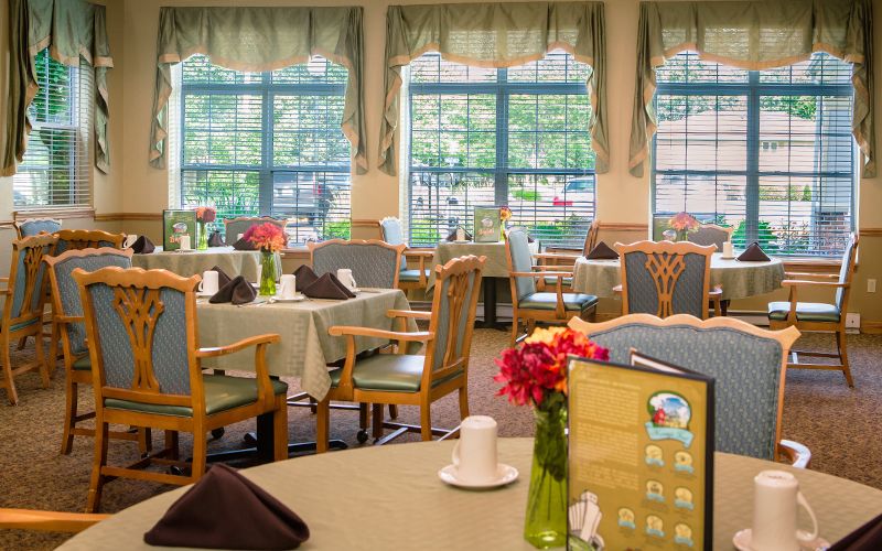 Interior view of Bickford Macomb Cottage senior living community with dining area and decor.