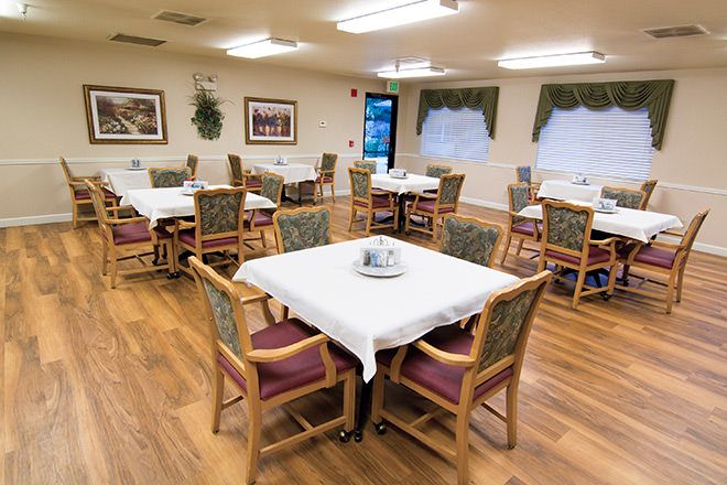Interior view of Brookdale Vista senior living community featuring dining room with wooden furniture.