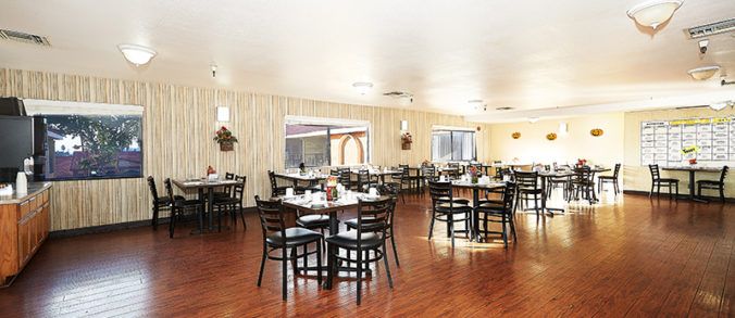 Interior view of Vista Montana Senior Living featuring dining room with hardwood furniture.