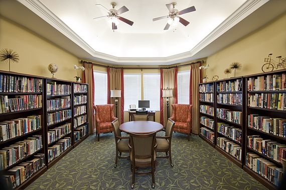 Senior living community library at Allegro St. Augustine with books, furniture, and electronics.