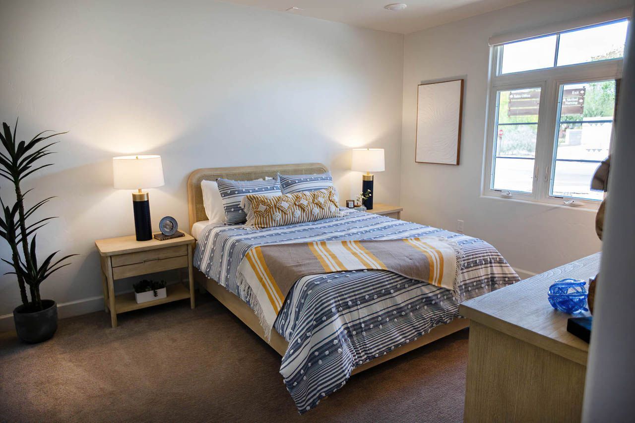 Interior view of a well-furnished bedroom at The Hacienda At The River senior living community.