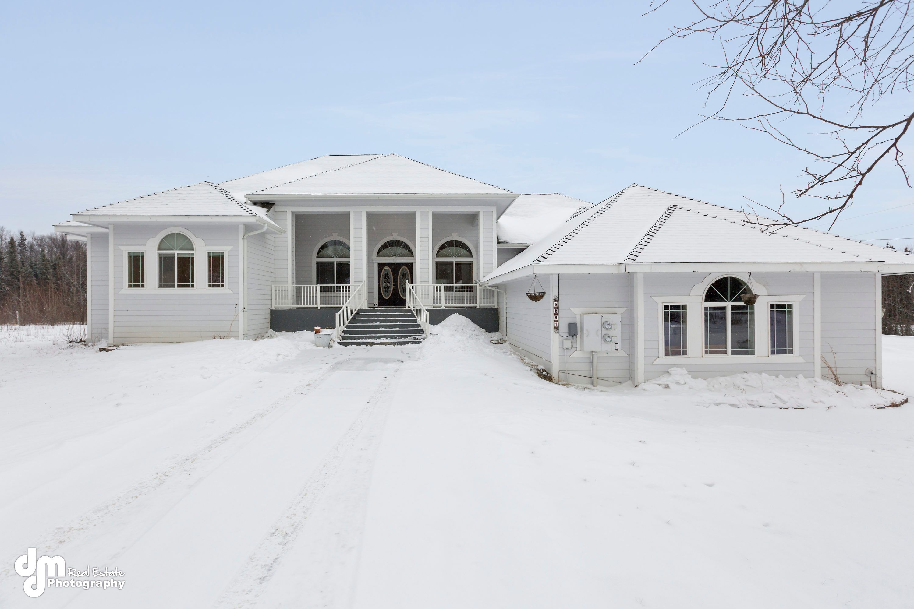 Arctic Rose Assisted Living Home exterior in winter, surrounded by snow-covered nature.