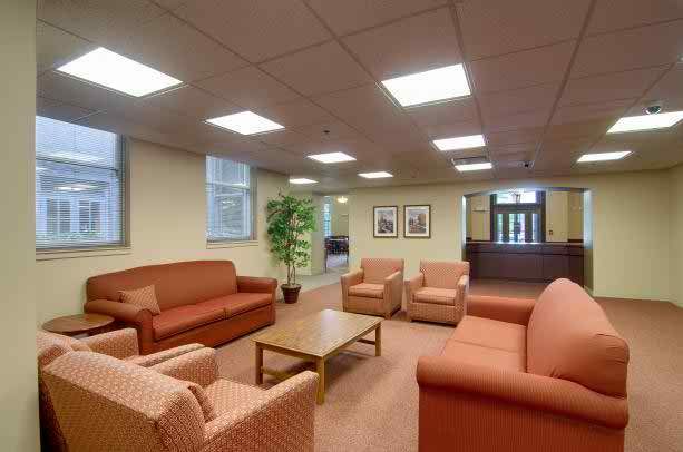 Interior view of Senior Suites Joliet featuring a welcoming reception room with stylish furniture.