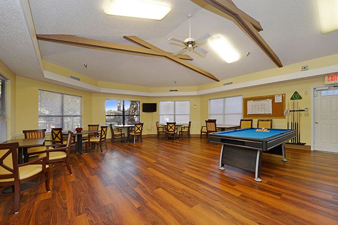 Interior view of Brookdale New Port Richey senior living community with dining and billiard room.
