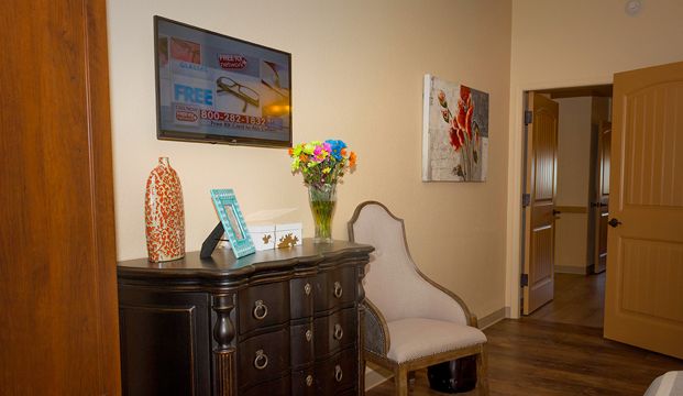 Interior view of Via Elegante - Sierra Vista senior living community with elegant furniture and flower arrangements.