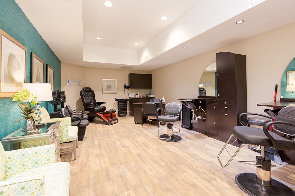 Senior enjoying amenities at The Enclave at Cedar Park Senior Living, featuring indoor salon.