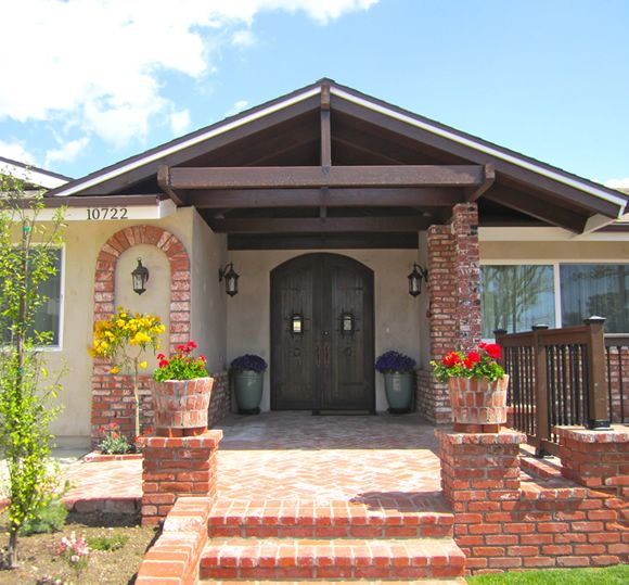 Cheerful Heart Home senior living community featuring a brick house with a portico, porch, and patio.