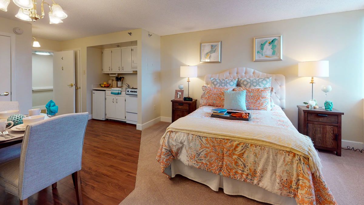 Interior design of a bedroom at Lake Howard Heights senior living community with cozy furniture.