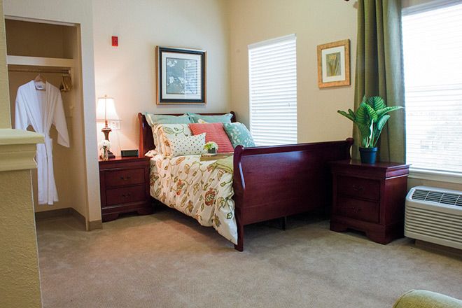 Interior view of a comfortable bedroom at Parmer Woods Senior Living in North Austin.