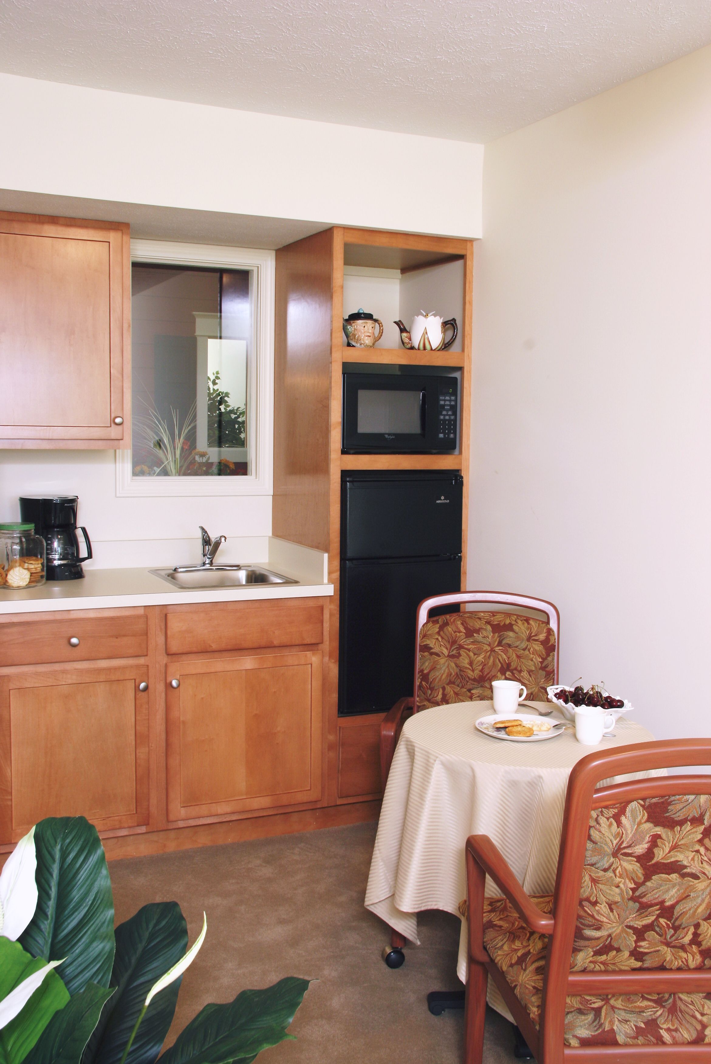 Interior view of Chestnut Fields Retirement Community featuring a well-designed kitchen and dining area.
