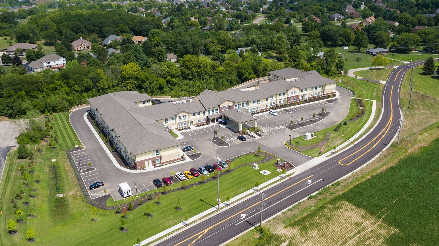 Aerial view of Mason Assisted Living & Memory Care community with buildings, roads, and cars.
