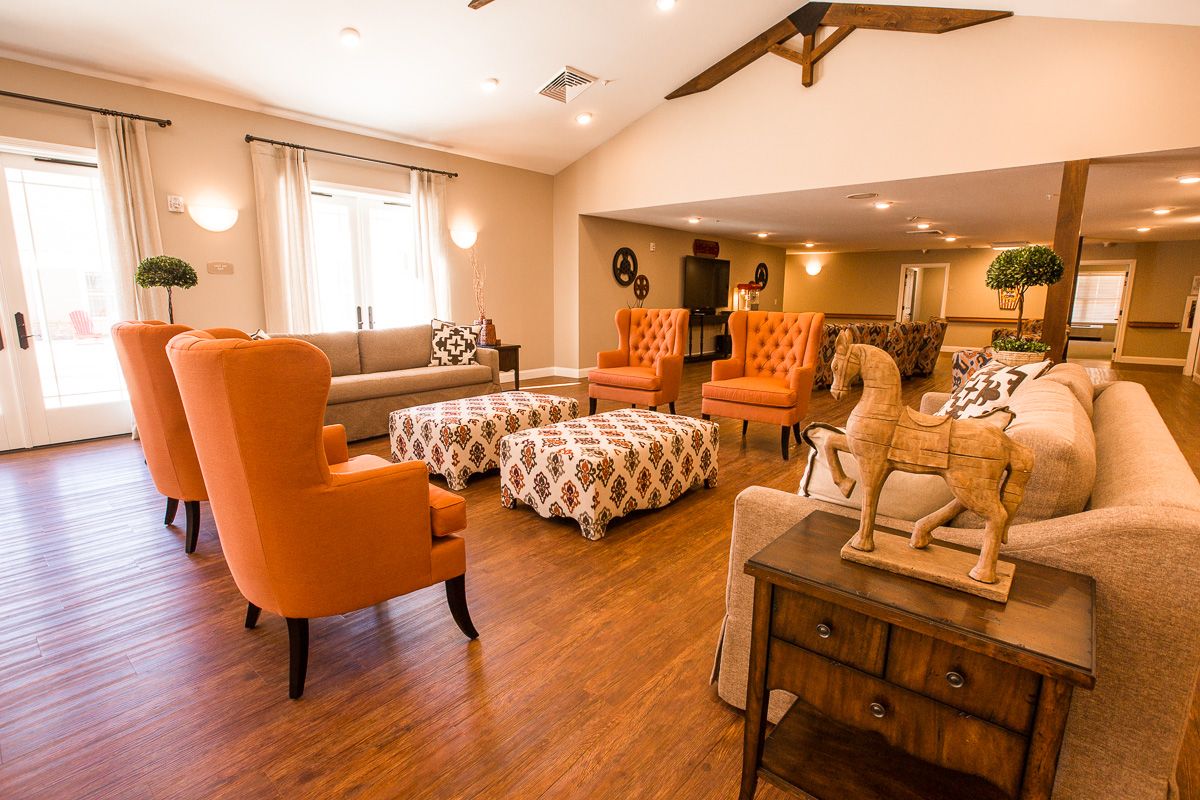Interior of a stylish senior living community with modern furniture, wooden flooring, and decor.