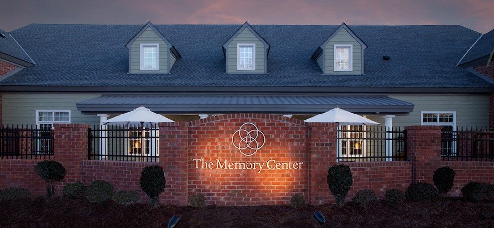 Brick senior living community, The Memory Center of Virginia Beach, featuring awning, canopy, and unique architecture.