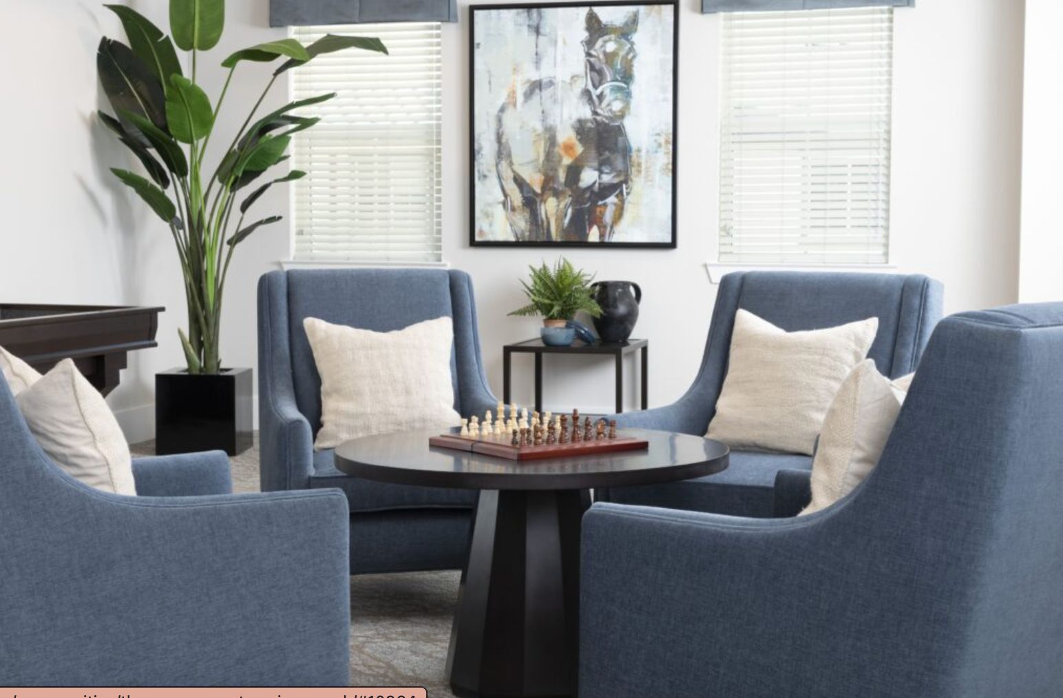 Senior living room interior at The Preserve at Spring Creek with home decor, furniture, and chess game.